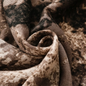Detailed macro view of soft textile fabric with brown and black leopard animal print pattern