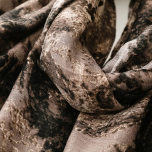 Detailed macro texture of vintage marble print scarf in dark brown and black tones