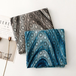 Detail of printed ethnic scarves with mandala patterns and delicate fringe edges