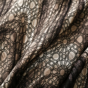 Close-up of geometric floral print on cotton linen feel scarf with soft texture
