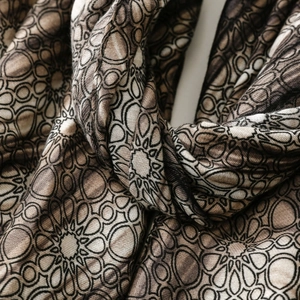 Close-up of vintage geometric pattern and fiber texture on a soft linen feel scarf
