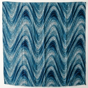 Close-up of blue geometric floral print scarf with soft fringed edges for women