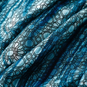 Detailed macro view of blue mandala geometric print on soft textile scarf fabric