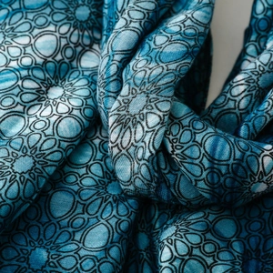 Detailed macro view of blue geometric floral pattern on soft cotton linen scarf fabric