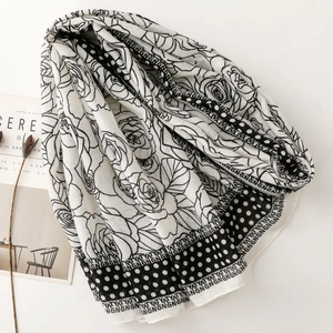 Detail of floral and polka dot print on soft lightweight shawl with decorative letters