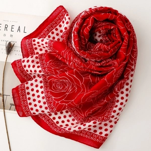 Detailed pattern of floral and polka dot print on red and white lightweight scarf shawl