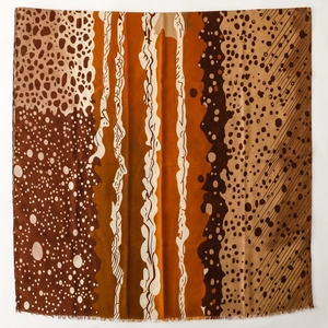 Detailed view of the soft frayed edges and earthy patchwork patterns on this long scarf