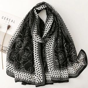 Elegant black and white floral polka dot long scarf styled with a minimalist magazine