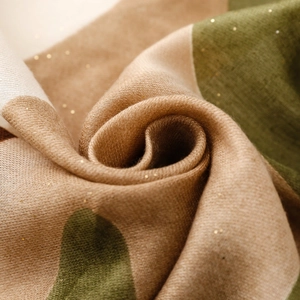 Détail macro du tissu pashmina tricolore avec reflets dorés et texture de tissage sergé