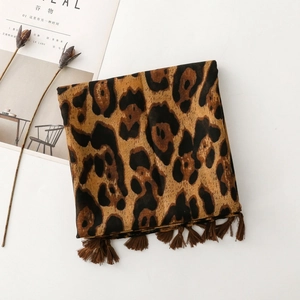 Detail of leopard print scarf with soft tassels and warm mixed fabric texture