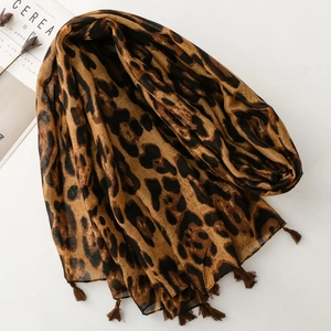 Fashionable leopard print scarf for women featuring light fabric and brown tassel edges