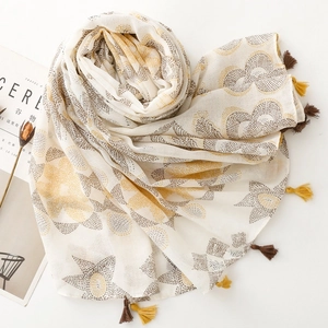 Ethnic bohemian scarf with yellow geometric floral patterns and fringe tassels on white