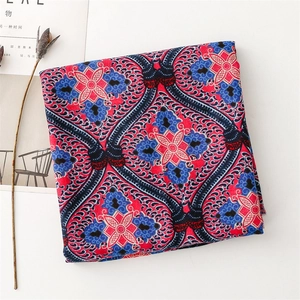 Détail d'une écharpe bohème avec motifs ethniques sur tissu coton-lin et imprimé rouge et bleu