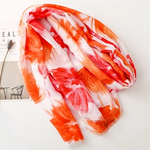 Artistic herringbone scarf with vibrant orange floral print and delicate fringed edges