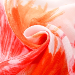 Macro view of scarf fabric showing soft cotton linen texture and floral watercolor print