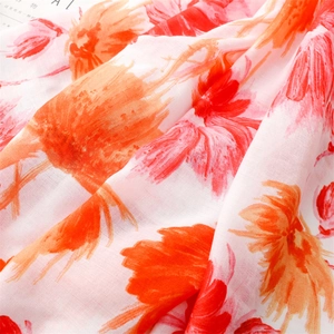 Close-up of herringbone texture and vibrant red floral print on soft cotton linen scarf