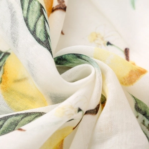Macro shot of lightweight lemon print fabric showing fine woven texture and soft drape