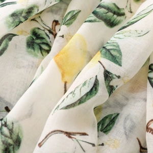 Detail of lightweight lemon print scarf showing sheer fabric texture and vibrant fruit pattern