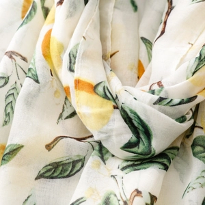 Close-up of lemon print scarf with fine weave texture and fresh yellow citrus pattern