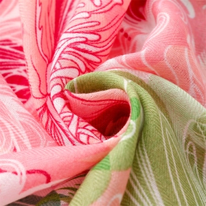 Close-up of pink cotton-linen scarf showing soft texture and floral weaving patterns