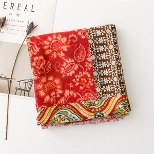 Close-up of vintage ethnic floral scarf with paisley patterns and fringe details