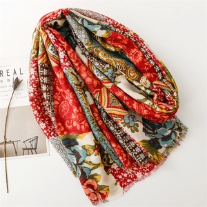 Macro shot of ethnic boho floral print shawl with fine fringed edges and soft texture