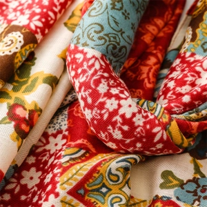 Detailed close-up showing the intricate paisley patterns and fine texture of the woven scarf