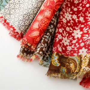 Detail of vintage ethnic floral scarves with paisley patterns and fringe edges