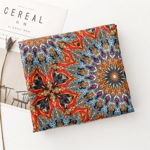 Detail of bohemian cotton linen scarf featuring vibrant mandala patterns and ethnic style