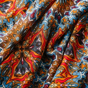 Macro detail of Bohemian cotton linen shawl with colorful geometric mandala patterns