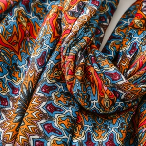 Detail of bohemian cotton linen scarf with colorful paisley patterns and herringbone weave