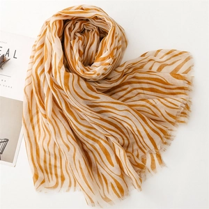 Elegant zebra print lightweight scarf shawl with fringed edges in orange and beige
