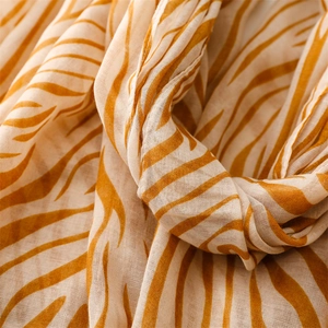 Detail shot of lightweight orange zebra print scarf showing high-density voile texture