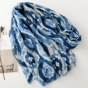 Blue and white floral Bali yarn scarf with fringe detail and artistic pattern design