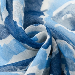 Detailed macro view of blue geometric print Bali yarn scarf fabric with frayed edges