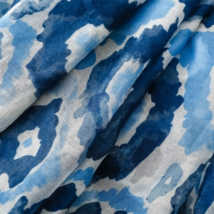 Close-up of blue geometric abstract pattern on soft Bali yarn scarf with raw edges