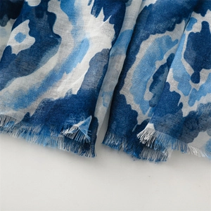 Detail of blue geometric print Bali yarn scarf showing woven texture and frayed edges