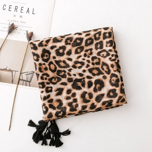 Detail of leopard print scarf with soft texture and stylish black tassel fringe edges