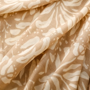 Close-up of lightweight cotton-linen scarf fabric with khaki floral and leaf patterns