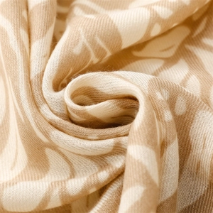 Macro detail of breathable cotton linen scarf fabric with elegant botanical leaf patterns
