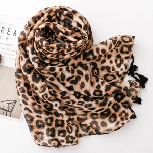 Detail of leopard print scarf featuring delicate black tassels and lightweight fabric