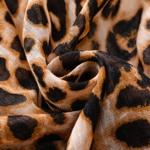 Close-up of leopard print bali gauze scarf showing soft woven texture and fringe detail