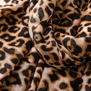 Close-up detail of leopard print scarf showing soft voile texture and fine fringe
