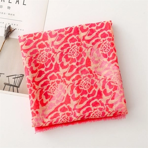 Detail of floral voile scarf with raw fringe edges and elegant large flower patterns