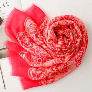Macro shot of red floral scarf with raw edges folded into a creative heart shape