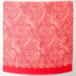Fashionable bali gauze scarf with pink floral print and frayed edges on deep red base