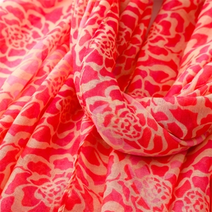 Detail shot of lightweight floral chiffon scarf with vibrant rose pink petals and soft edges