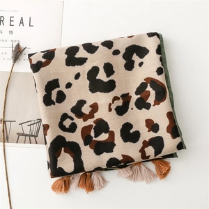 Close-up of leopard print cotton linen scarf featuring stylish fringe trim and soft texture
