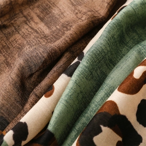 Macro detail of vintage green and leopard print cotton-linen blend fabric texture