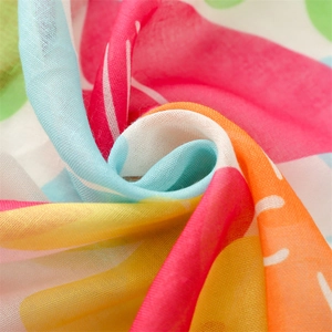 Macro detail of lightweight Bali yarn scarf with colorful floral print and soft texture